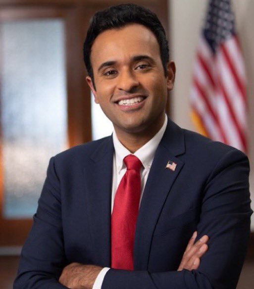 There is no crypto chart in this image. The image shows a person in a navy suit 